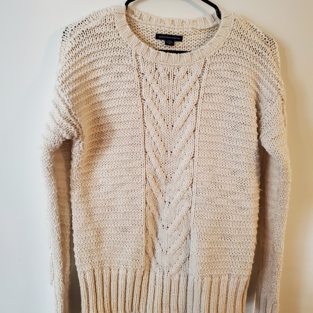 Cream colored sweater.